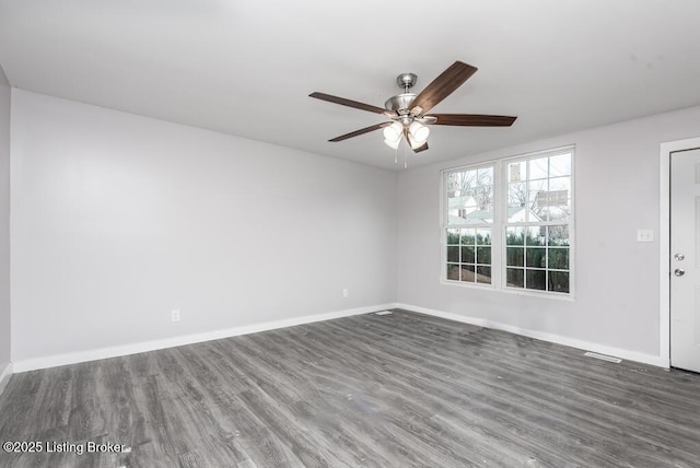 spare room with ceiling fan and dark hardwood / wood-style flooring