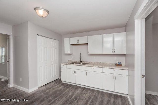 kitchen featuring sink, white cabinetry, and dark hardwood / wood-style floors