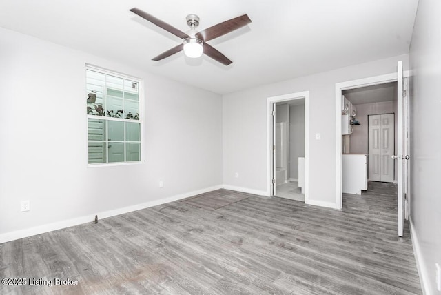 unfurnished bedroom with ceiling fan, hardwood / wood-style floors, and ensuite bath