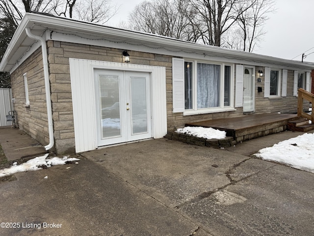 entrance to property with a patio area and french doors