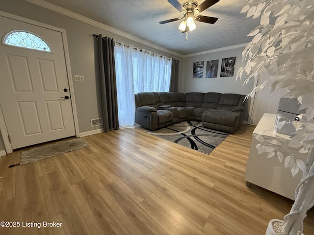 unfurnished living room with ornamental molding, hardwood / wood-style floors, and ceiling fan