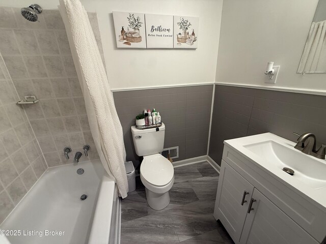 full bathroom featuring tile walls, vanity, shower / bath combination with curtain, and toilet