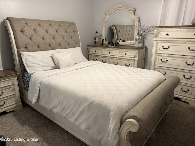 bedroom with dark colored carpet