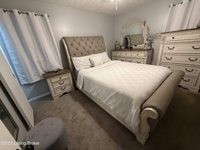 carpeted bedroom with a textured ceiling