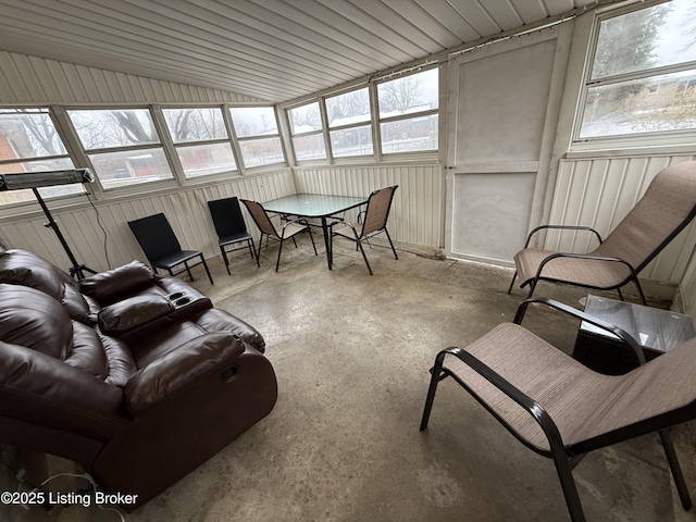 sunroom with vaulted ceiling and a healthy amount of sunlight