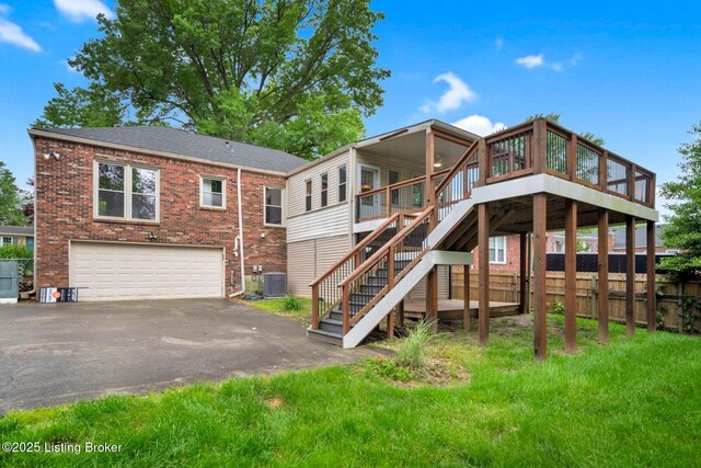 8923 La Costa Rd, Jeffersontown, KY 40299 - back of house with a garage, asphalt driveway, stairway, central air condition unit, and brick siding