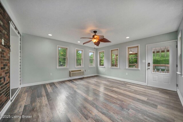 8923 La Costa Rd, Jeffersontown, KY 40299 - unfurnished living room with a ceiling fan, wood finished floors, recessed lighting, baseboards, and a wall mounted AC