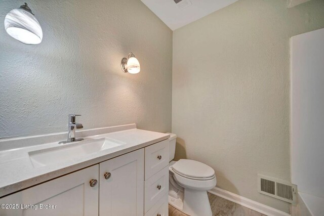 8923 La Costa Rd, Jeffersontown, KY 40299 - bathroom featuring toilet, vanity, and baseboards
