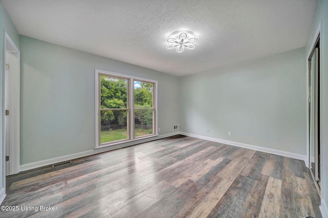 8923 La Costa Rd, Jeffersontown, KY 40299 - unfurnished bedroom with wood finished floors, a textured ceiling, and baseboards