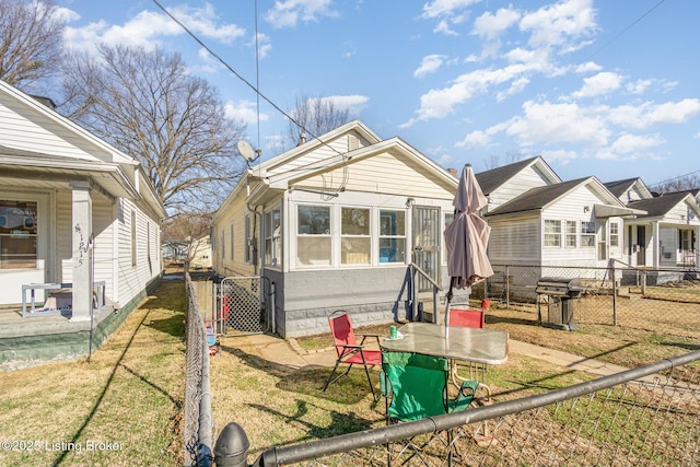 rear view of property with a yard