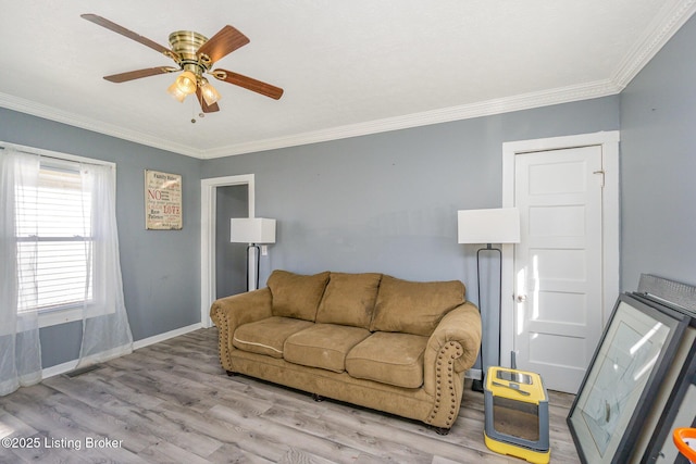 living room featuring ornamental molding, ceiling fan, and light hardwood / wood-style flooring