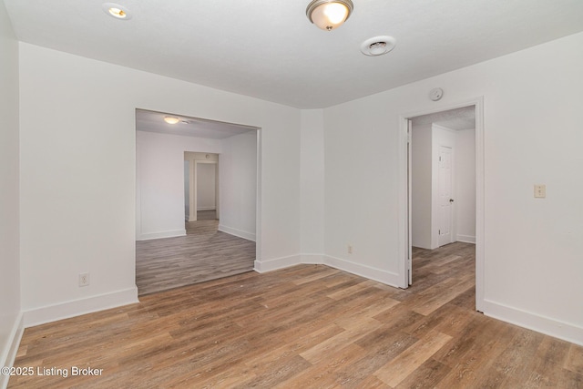 unfurnished room with hardwood / wood-style flooring