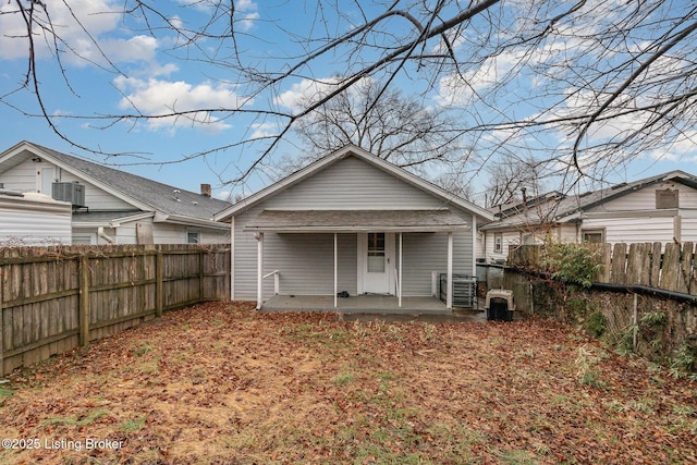 rear view of property with cooling unit and a patio area