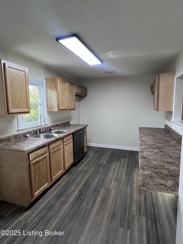 kitchen featuring dishwasher, sink, dark hardwood / wood-style flooring, and a textured ceiling