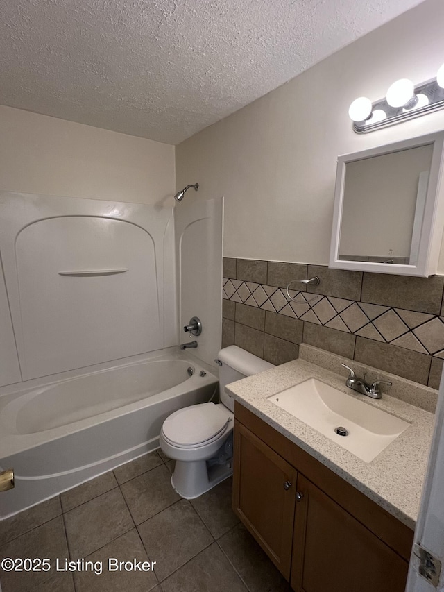 full bathroom with a textured ceiling, tile patterned floors, shower / washtub combination, tile walls, and toilet