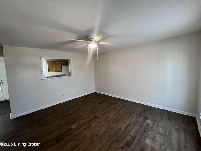 empty room featuring dark wood-type flooring and ceiling fan