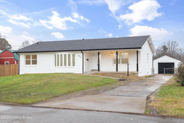 single story home featuring a garage, a front yard, an outbuilding, and a porch