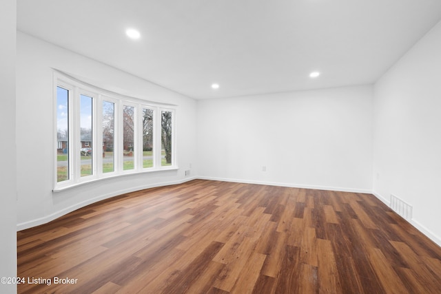 spare room featuring dark hardwood / wood-style floors