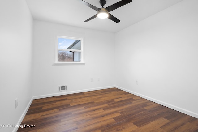 spare room featuring ceiling fan and dark hardwood / wood-style flooring