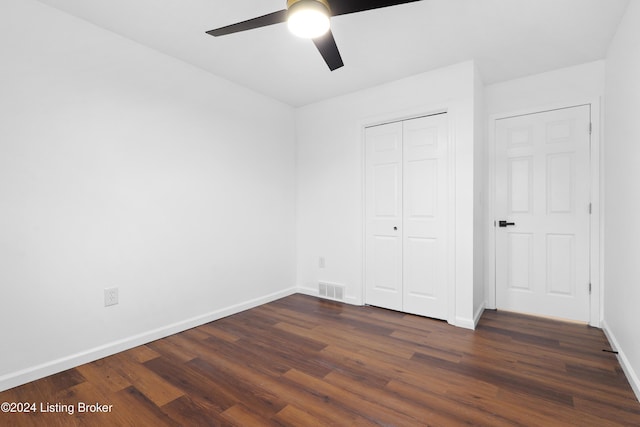 unfurnished bedroom featuring ceiling fan, a closet, and dark hardwood / wood-style floors