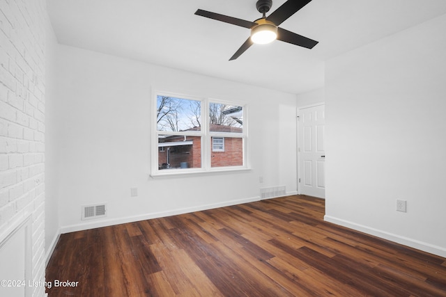 empty room featuring ceiling fan and dark hardwood / wood-style floors