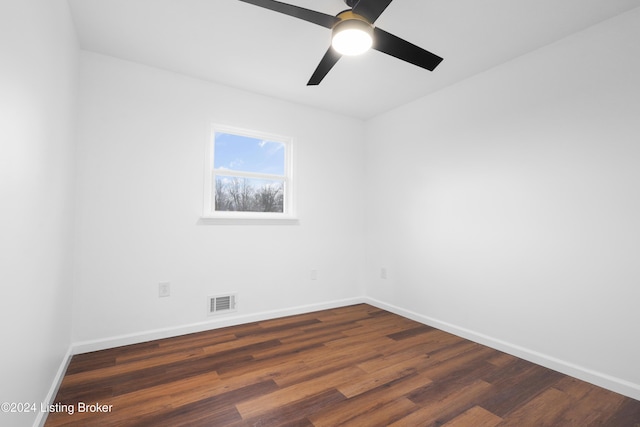 empty room featuring ceiling fan and dark hardwood / wood-style flooring