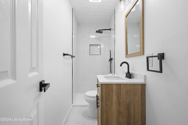 bathroom with walk in shower, vanity, toilet, and a textured ceiling