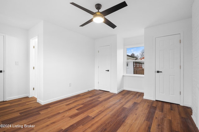 unfurnished room featuring dark wood-type flooring and ceiling fan