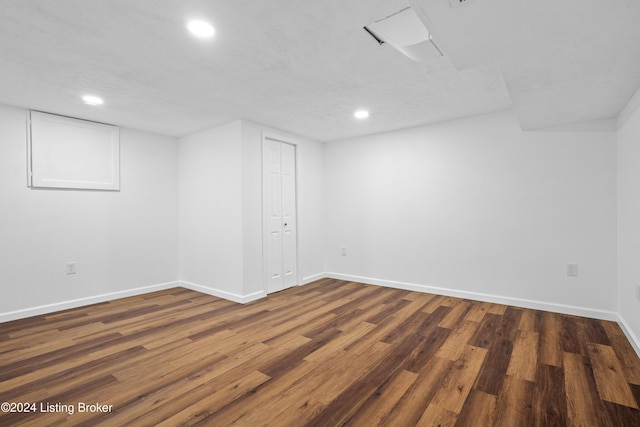 basement with dark hardwood / wood-style floors