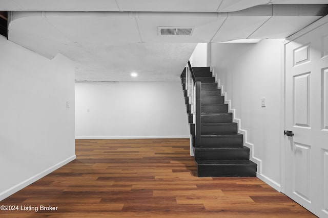 basement with dark hardwood / wood-style flooring