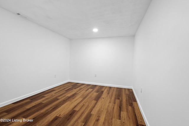 spare room with dark hardwood / wood-style floors