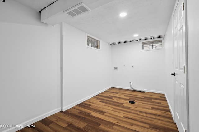 laundry area with hookup for an electric dryer, dark hardwood / wood-style floors, hookup for a gas dryer, hookup for a washing machine, and a textured ceiling