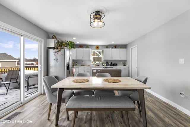 dining area with hardwood / wood-style floors