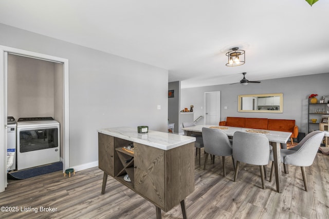 dining room with washer and dryer, dark hardwood / wood-style floors, and ceiling fan