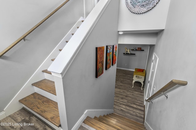 stairway with hardwood / wood-style floors