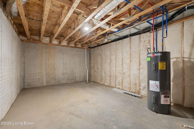 unfinished below grade area featuring water heater and brick wall