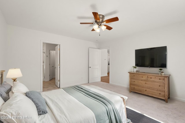 carpeted bedroom with ceiling fan and baseboards