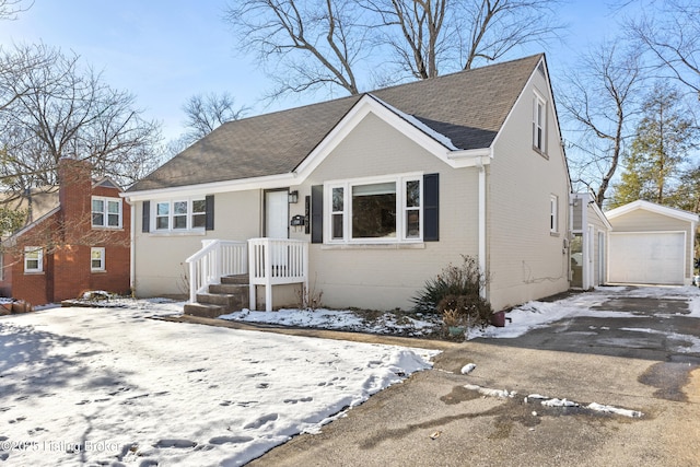 view of front facade with a garage and an outbuilding