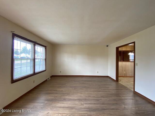 empty room with hardwood / wood-style flooring