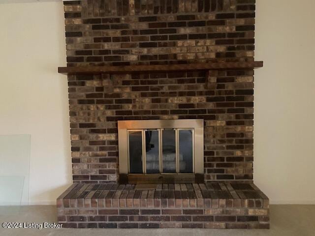 room details featuring a brick fireplace