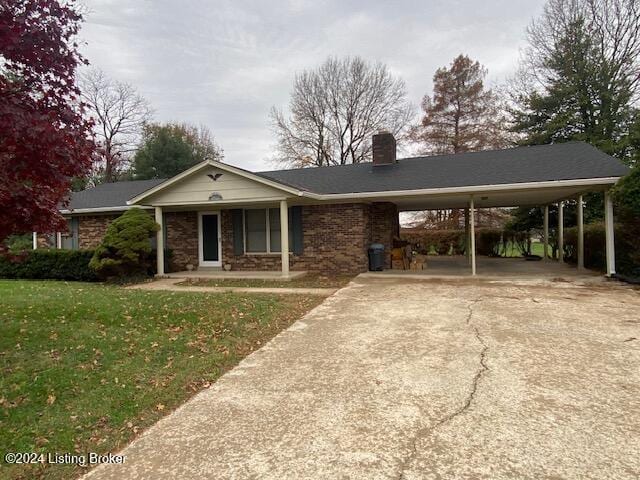 view of front of home with a carport, covered porch, and a front yard