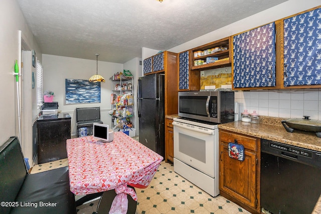 kitchen with light stone countertops, pendant lighting, a textured ceiling, black appliances, and tasteful backsplash