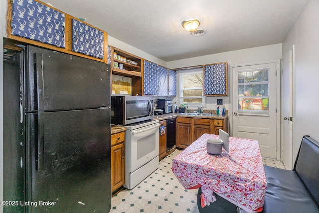 kitchen featuring sink and black appliances