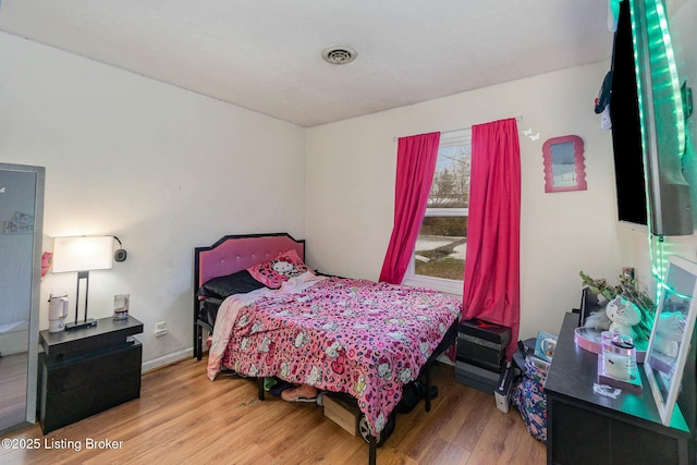 bedroom with hardwood / wood-style floors