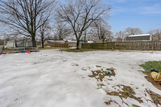 snowy yard with a trampoline