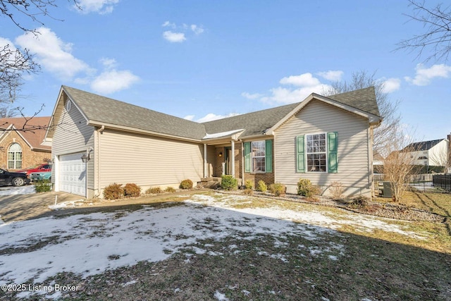 single story home with a garage and central air condition unit