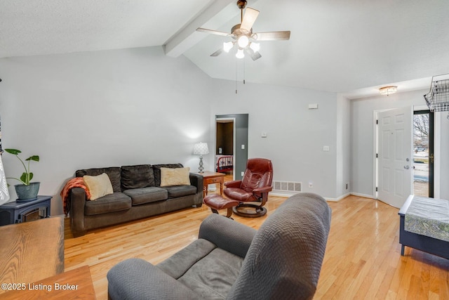 living room featuring a textured ceiling, lofted ceiling with beams, light hardwood / wood-style flooring, and ceiling fan