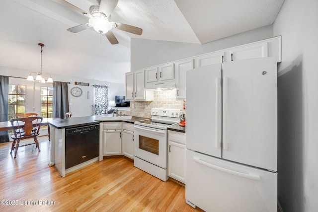 kitchen with white appliances, white cabinets, decorative backsplash, sink, and hanging light fixtures