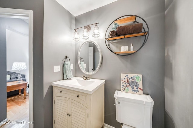 bathroom featuring vanity, toilet, and wood-type flooring