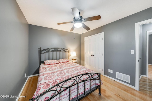 bedroom featuring wood-type flooring, a closet, and ceiling fan